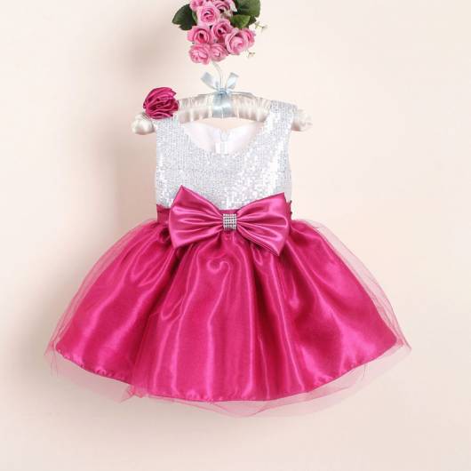 Modelo de vestido rosa e branco com laço na cintura.